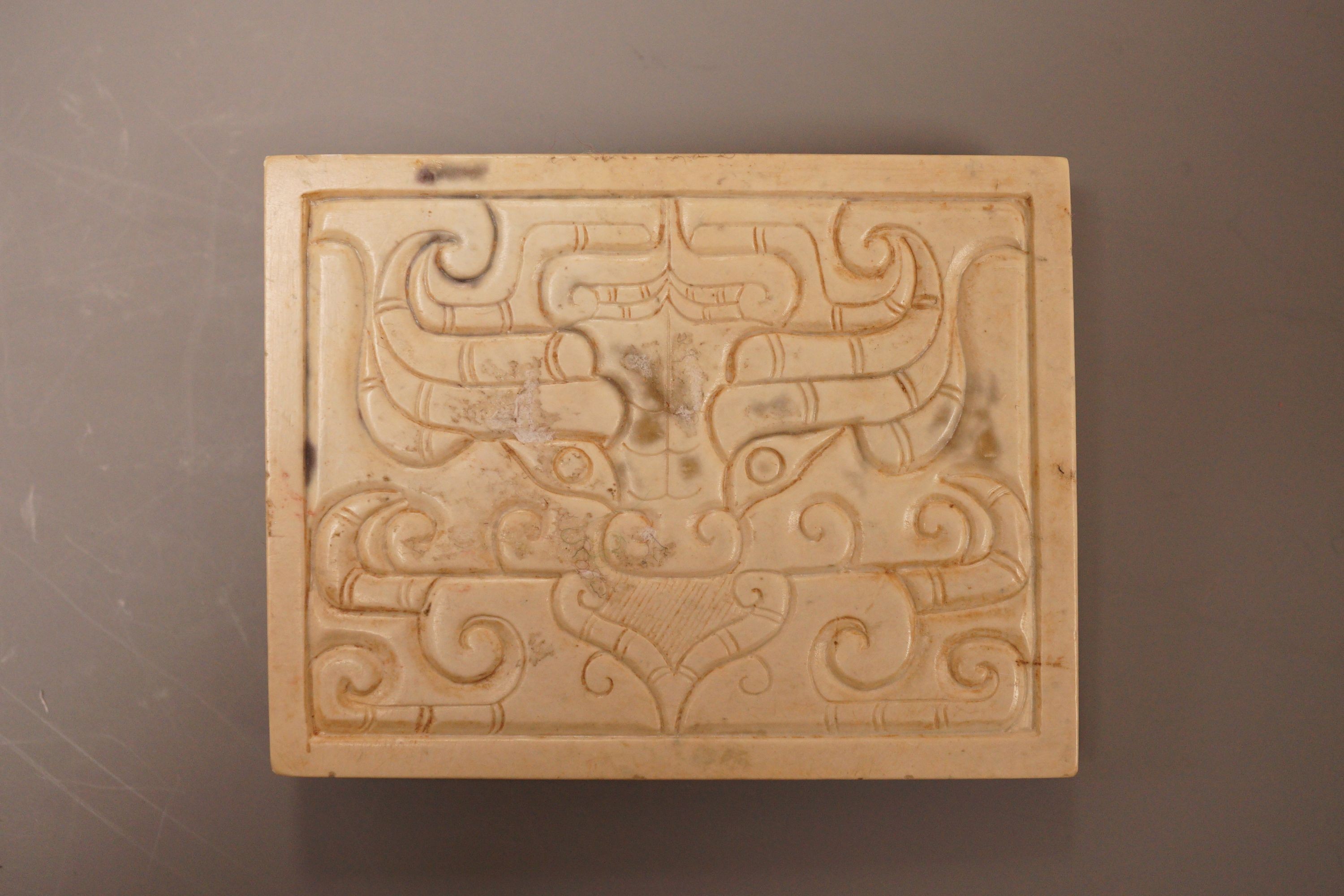 A Chinese burnt jade and bronze plaque